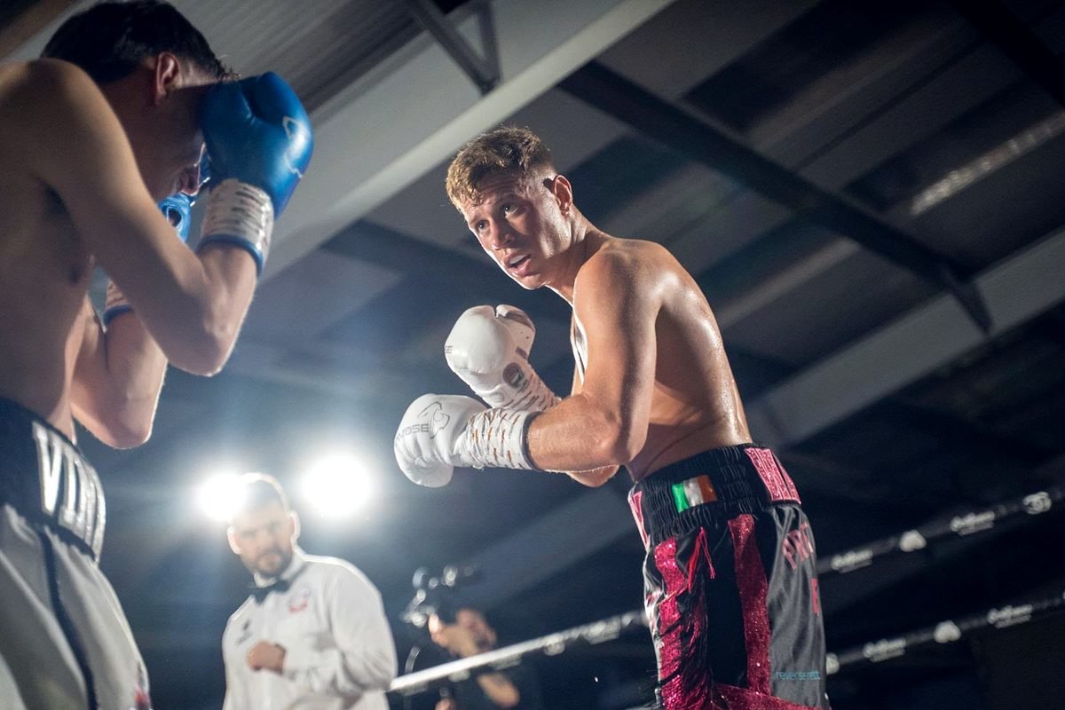 Paddy Walsh in fighting stance under the lights during a bout